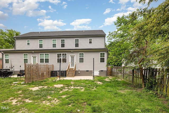 back of house with a yard and central AC unit