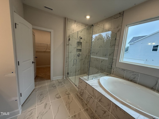 bathroom with shower with separate bathtub