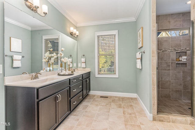 bathroom with tiled shower, vanity, and crown molding