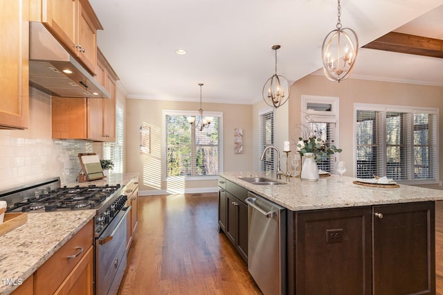 kitchen featuring light stone countertops, stainless steel appliances, dark wood-type flooring, sink, and a center island with sink