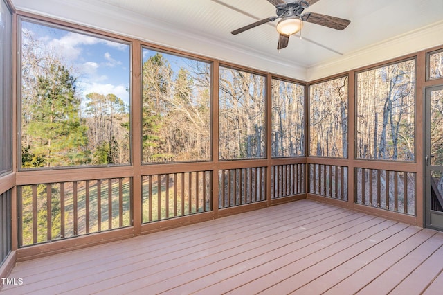 unfurnished sunroom with ceiling fan