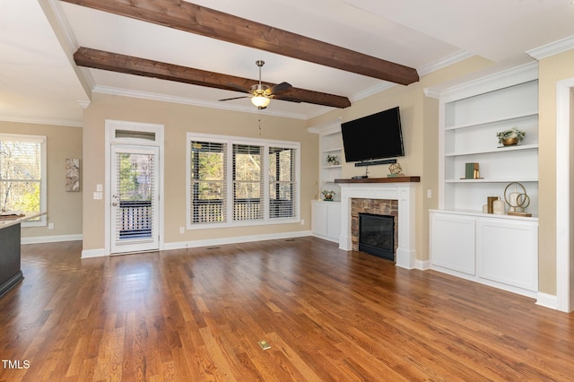 unfurnished living room featuring hardwood / wood-style flooring, built in shelves, ceiling fan, and crown molding