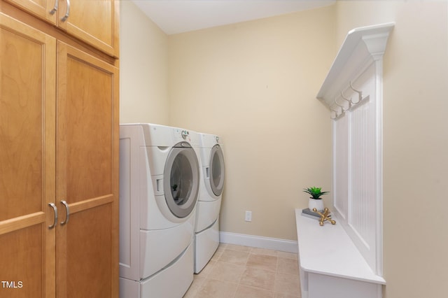 laundry room with cabinets and washing machine and clothes dryer