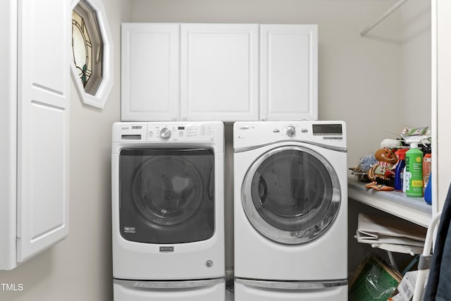 laundry room featuring cabinets and washing machine and dryer