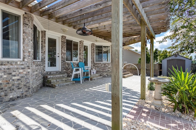 view of patio featuring ceiling fan and a storage unit