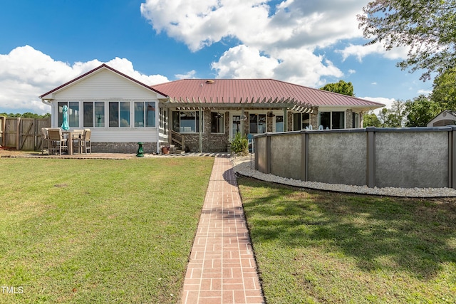 view of front of home featuring a sunroom and a front yard