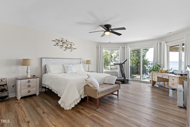 bedroom featuring access to outside, ceiling fan, and dark hardwood / wood-style flooring