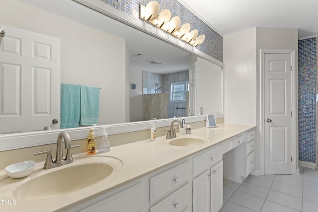 bathroom with tiled shower, vanity, and tile patterned floors