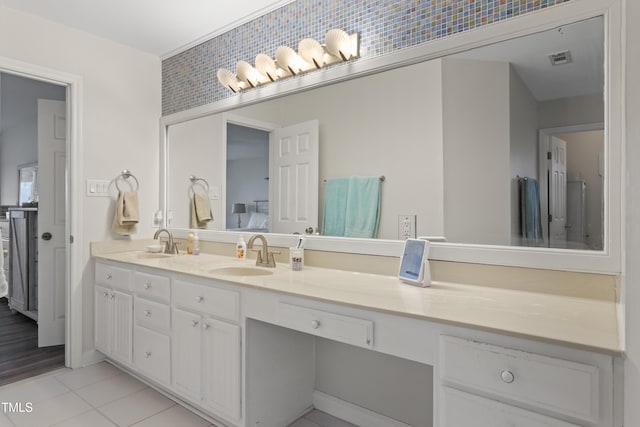 bathroom with tile patterned flooring, vanity, and backsplash