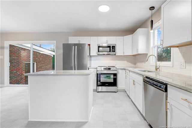 kitchen with white cabinets, light stone countertops, sink, and appliances with stainless steel finishes