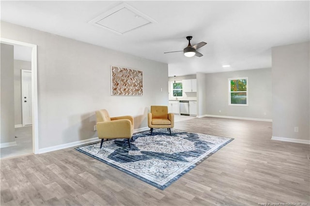 living area with ceiling fan and light hardwood / wood-style floors