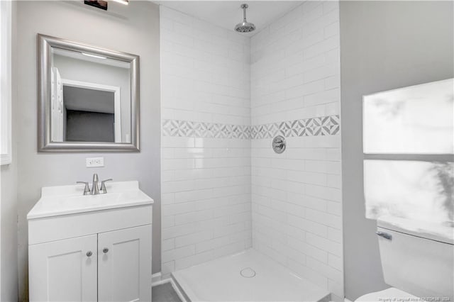 bathroom featuring vanity and tiled shower