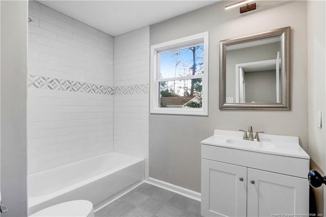 full bathroom featuring vanity, toilet, and tiled shower / bath