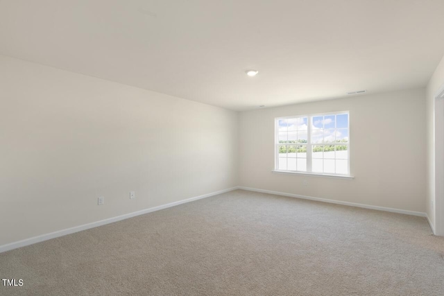 unfurnished room featuring light carpet