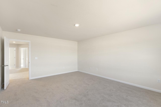 unfurnished room featuring light carpet