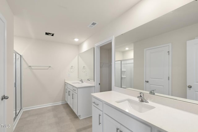 bathroom featuring vanity and a shower with door