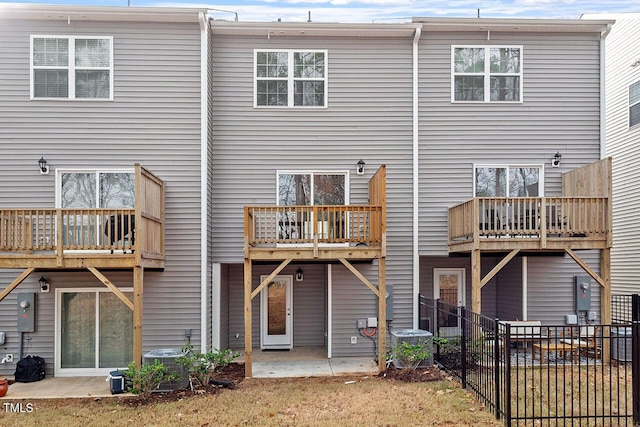 rear view of house with central AC and a patio