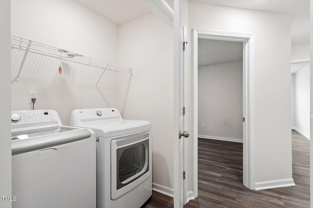 laundry room with dark wood-type flooring and washing machine and clothes dryer