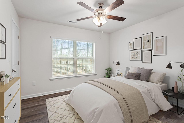 bedroom with ceiling fan and dark hardwood / wood-style flooring