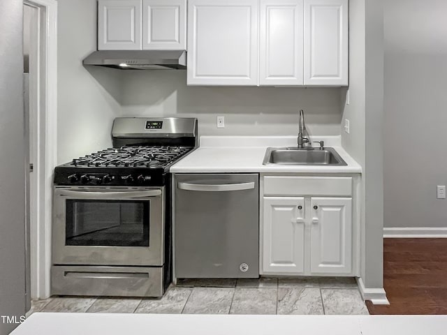 kitchen featuring sink, white cabinets, stainless steel appliances, and light hardwood / wood-style flooring