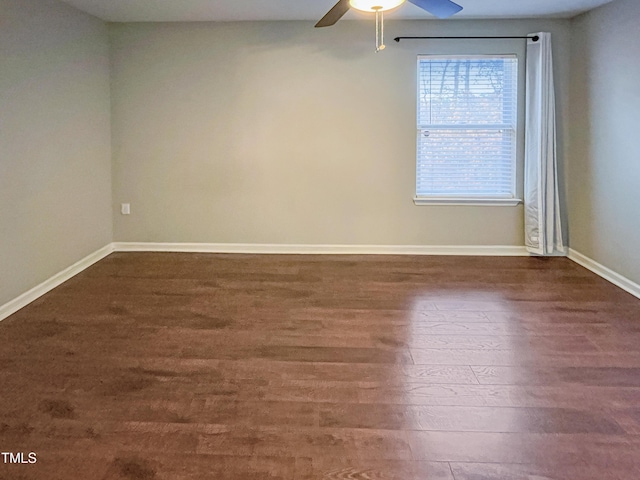 empty room with dark hardwood / wood-style flooring and ceiling fan