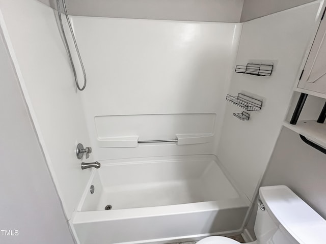 bathroom featuring shower / bathtub combination and toilet