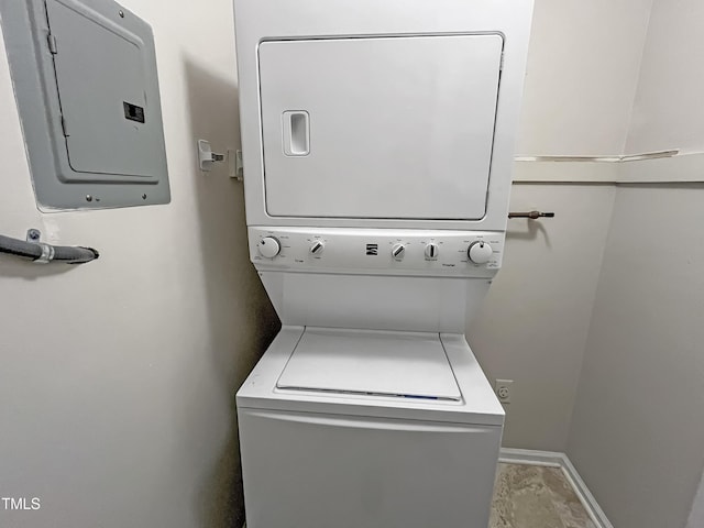 laundry room with electric panel and stacked washer and dryer