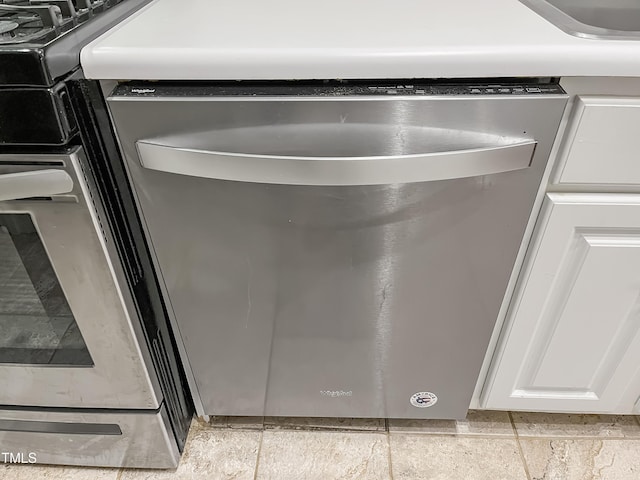 interior details with dishwasher and white cabinetry