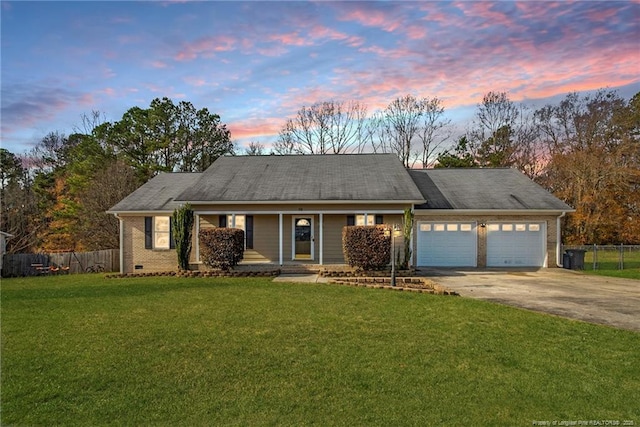 58 Bayleaf Ln, Sanford, NC 27332 - ranch-style home with concrete driveway, a garage, fence, and a lawn