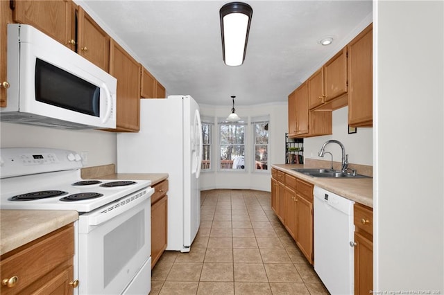 58 Bayleaf Ln, Sanford, NC 27332 - kitchen featuring light countertops, a sink, hanging light fixtures, light tile patterned floors, and white appliances