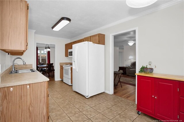 58 Bayleaf Ln, Sanford, NC 27332 - kitchen featuring light tile patterned flooring, white appliances, ornamental molding, and a sink