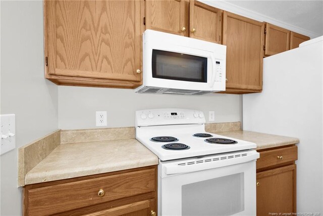 58 Bayleaf Ln, Sanford, NC 27332 - kitchen with white appliances, light countertops, and brown cabinets