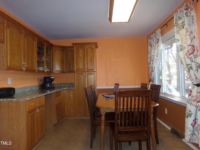 dining space featuring light colored carpet and a healthy amount of sunlight