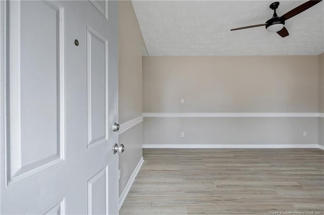 spare room with a textured ceiling, light hardwood / wood-style flooring, and ceiling fan