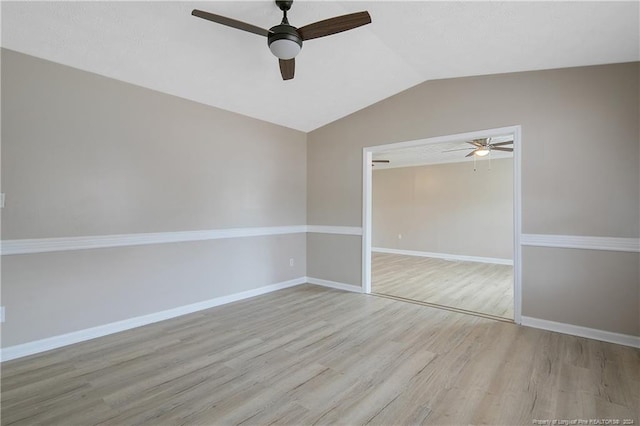 unfurnished room featuring light hardwood / wood-style floors, vaulted ceiling, and ceiling fan