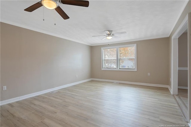 empty room with light wood-type flooring and ceiling fan