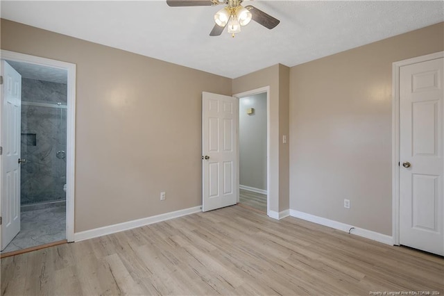 unfurnished bedroom with light hardwood / wood-style flooring, ensuite bath, and ceiling fan