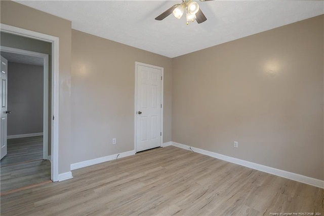 unfurnished bedroom with ceiling fan and light wood-type flooring