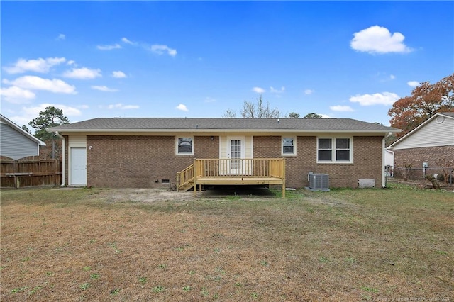 back of property with a lawn, a deck, and central air condition unit