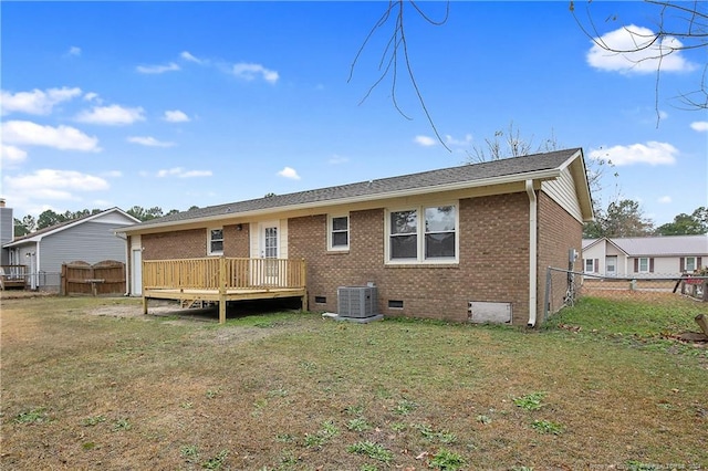 rear view of property with a yard, cooling unit, and a deck