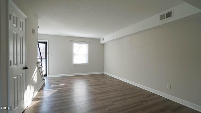 empty room with dark wood-type flooring