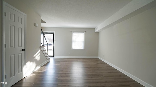 unfurnished room featuring dark wood-type flooring