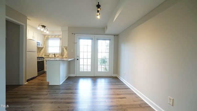 doorway to outside featuring dark hardwood / wood-style floors and sink