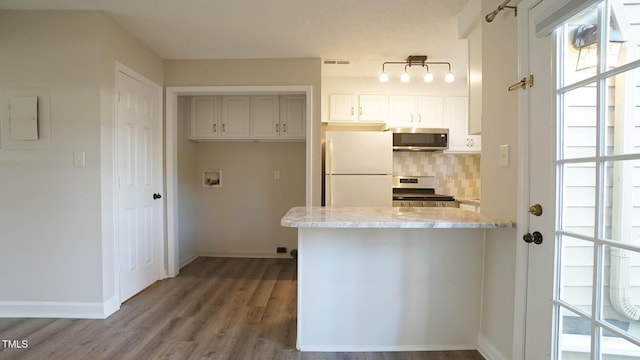 kitchen with backsplash, electric panel, white cabinets, light stone countertops, and stainless steel appliances