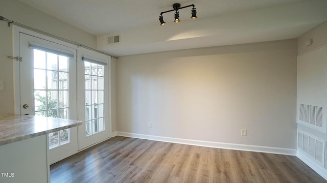 unfurnished dining area with light hardwood / wood-style flooring