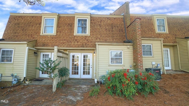 back of house with central air condition unit and french doors