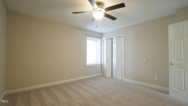 unfurnished bedroom featuring ceiling fan and light colored carpet