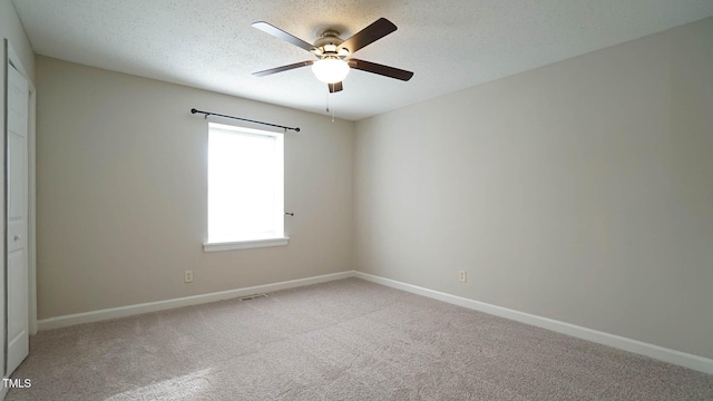 spare room with ceiling fan, carpet floors, and a textured ceiling