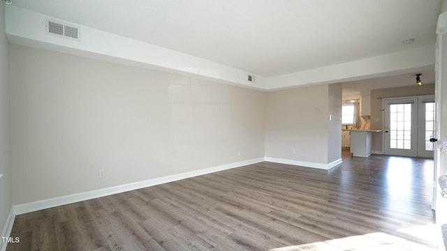 spare room with wood-type flooring