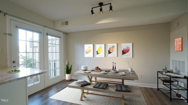 dining area featuring dark wood-type flooring